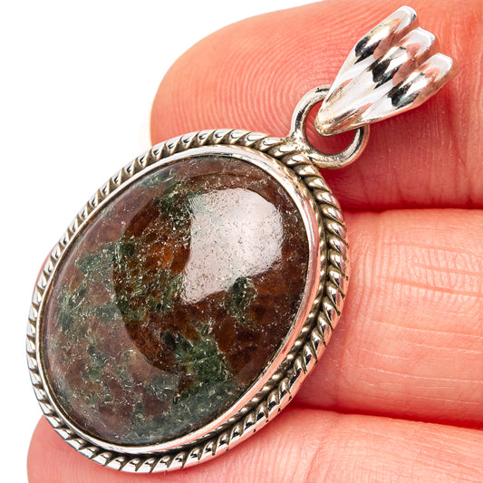 Sterling silver oval grass garnet pendant with textured rope bezel and loop bail