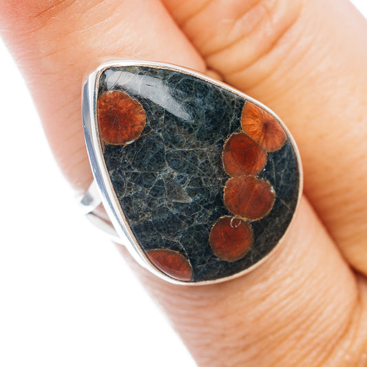 Sterling silver teardrop ring with dark obsidian center and copper heart inlays
