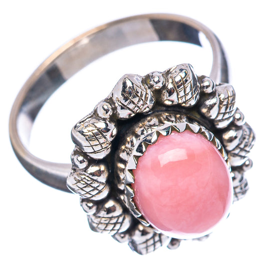 Pink opal cabochon ring with textured silver band and knotted bead setting