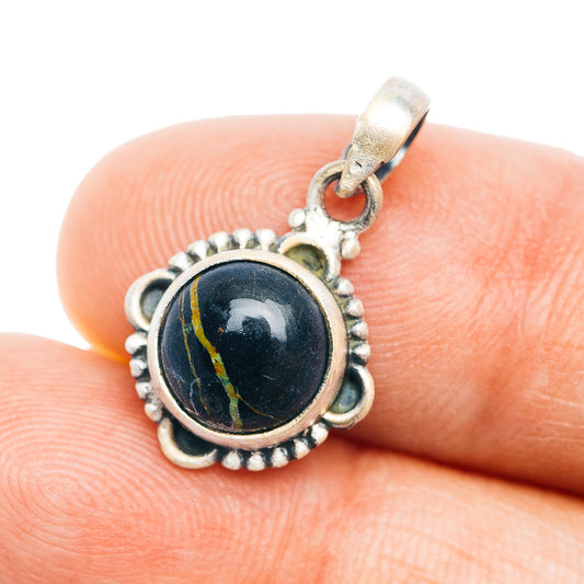 Sterling silver pendant with dark cabochon stone and decorative beaded edge