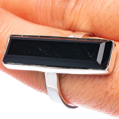 Rectangular black onyx ring in silver setting, close-up on bezel