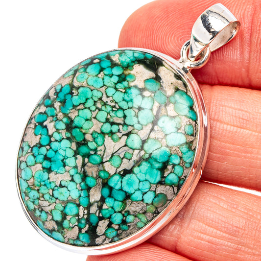 Oval turquoise pendant in .925 sterling silver bezel with loop bail; blue-green stone matrix.
