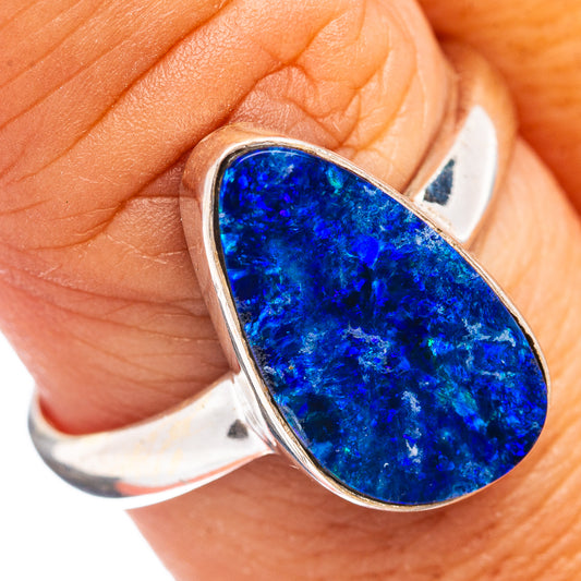 Sterling silver opal ring with blue oval stone, worn on finger, size 9