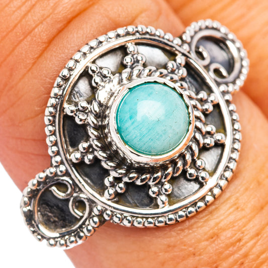 Sterling silver filigree ring with round turquoise cabochon, ornate side details