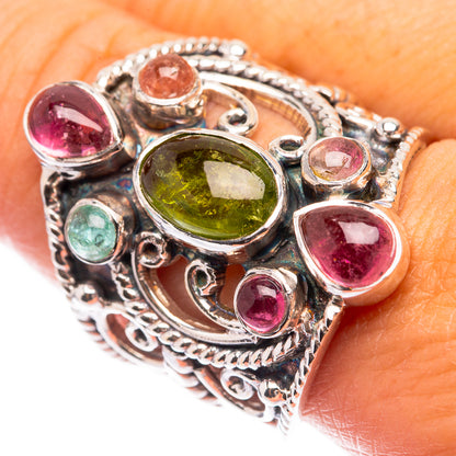 Silver ring with oval green stone and pink red gemstones in ornate setting