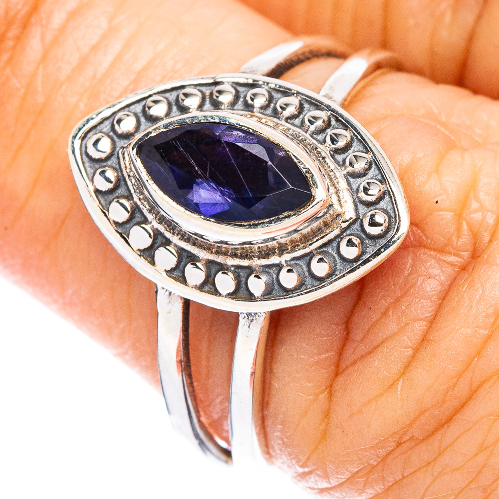 Sterling silver tanzanite ring with faceted oval blue-violet gemstone and ornate halo