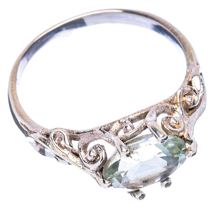Sterling silver ring with faceted green amethyst center and heart-like scroll detailing