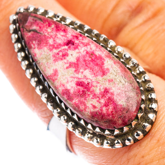 Adjustable sterling silver ring with teardrop pink thulite gemstone bezel setting