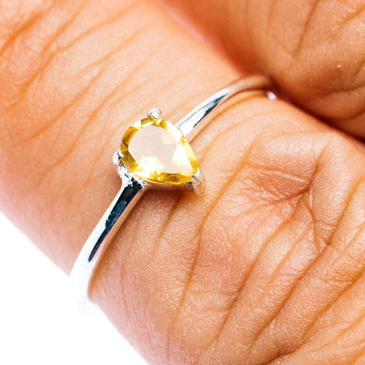 Stackable pear-cut citrine yellow gemstone ring with sterling silver band, open side detail