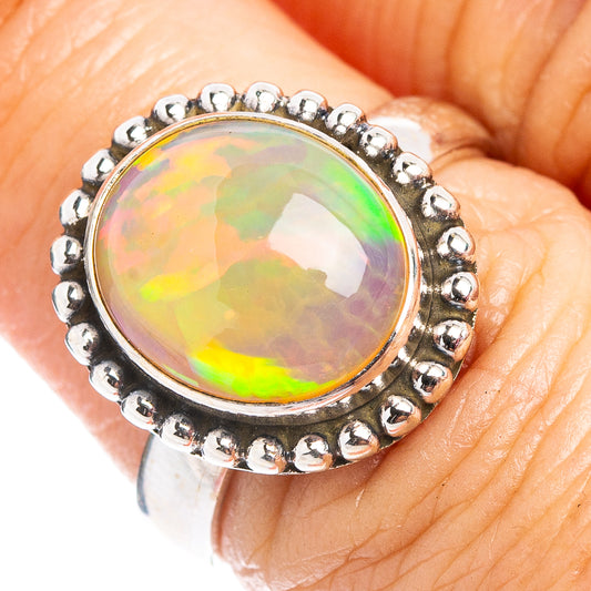 Sterling silver opal ring with oval cabochon and bead halo bezel