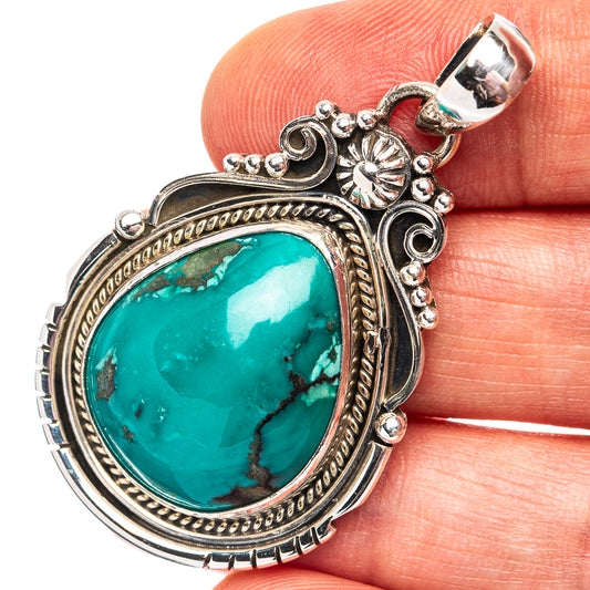 Turquoise oval pendant with ornate .925 sterling silver frame and top bail