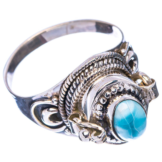 Sterling silver poison ring with blue oval cabochon and ornate rope, bead, and swirl details