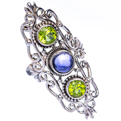 Ornate sterling silver ring with two round green stones and an oval blue gemstone