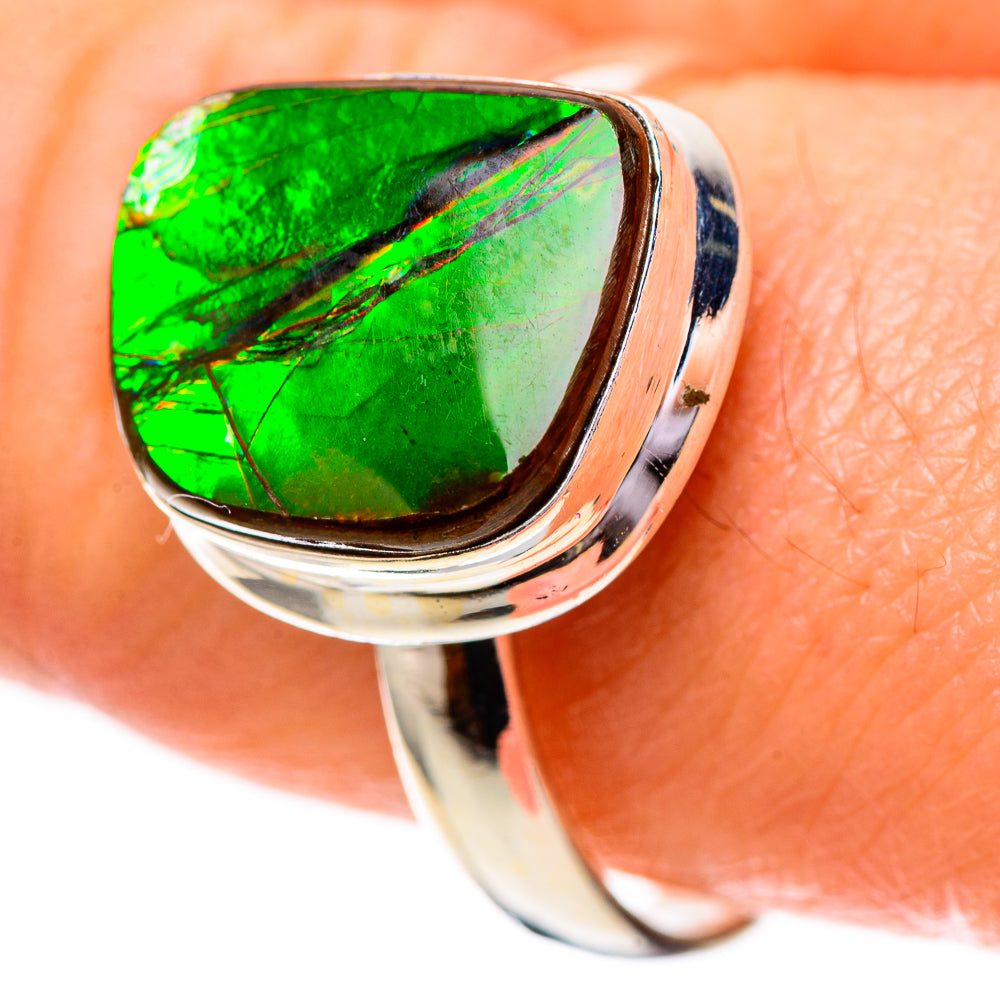 Sterling silver ammolite ring with oval green stone, polished band and raised setting