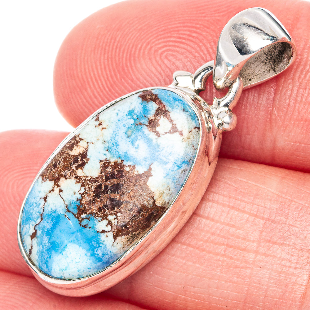 Oval turquoise cabochon pendant in 925 sterling silver with loop bail.