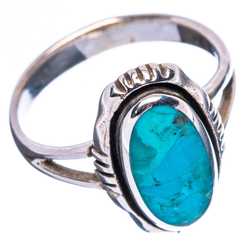 Oval turquoise cabochon silver ring with ornate bezel and engraved shoulders