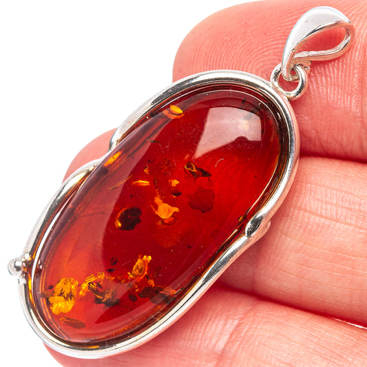 Oval Baltic amber pendant in .925 sterling silver, polished bezel setting