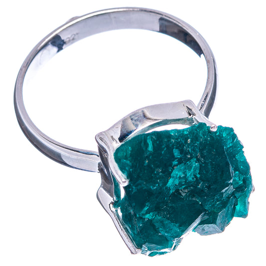 Sterling silver dioptase ring, teal faceted stone on prongs, metal band visible