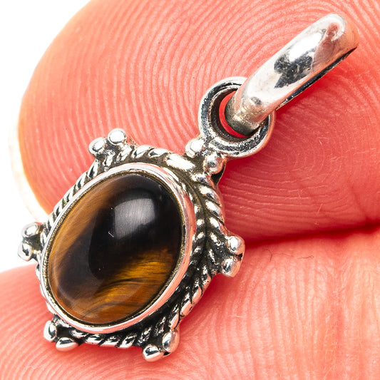 Oval tiger's eye pendant with ornate .925 sterling silver bezel and bail