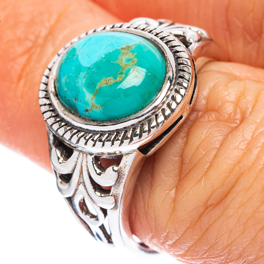 925 sterling silver turquoise oval ring on finger with ornate bezel setting