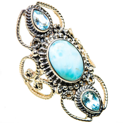 Ornate sterling silver ring with oval opalescent blue center and two blue oval stones