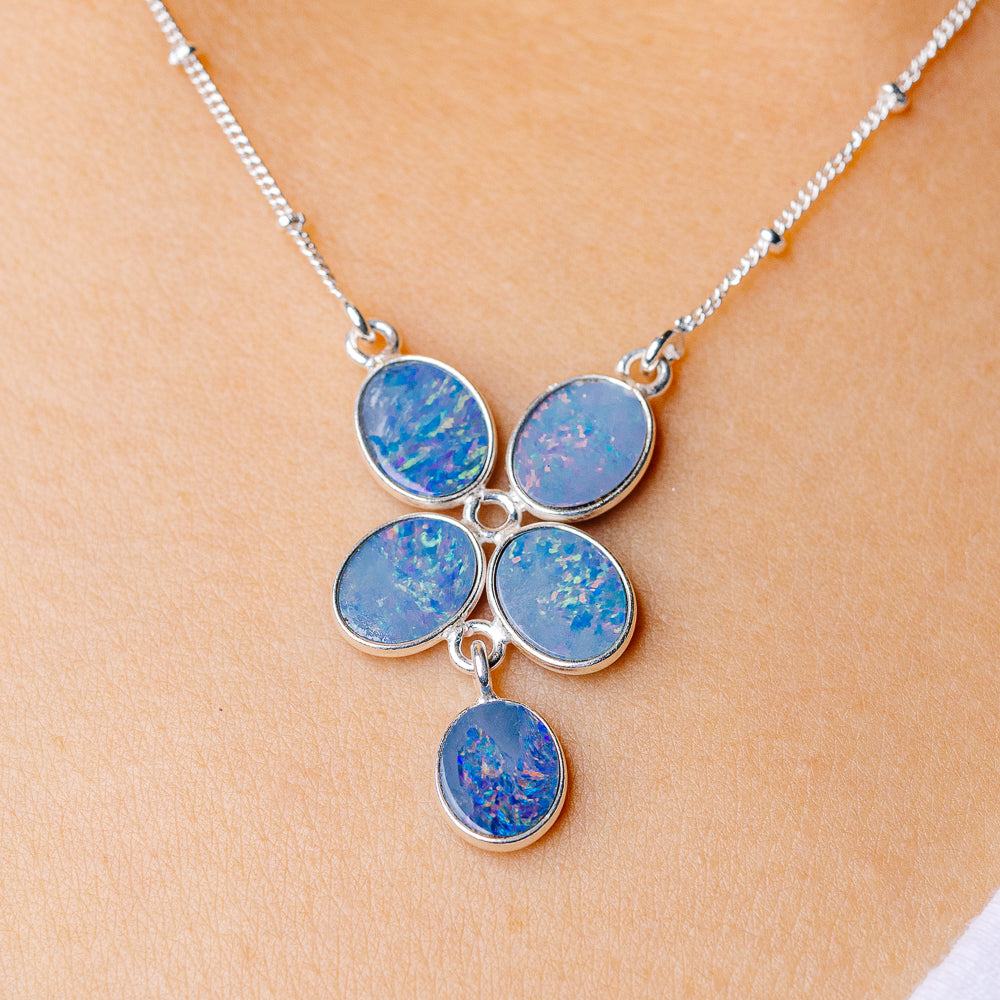 Sterling silver chain necklace with blue oval opal cluster pendant, five stones
