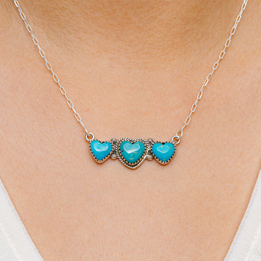 Turquoise and sterling silver three-stone necklace with heart-shaped settings and chain