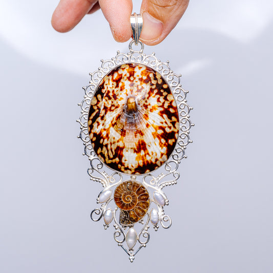Sterling silver pendant with oval fossil shell and cultured pearl accents, ornate filigree