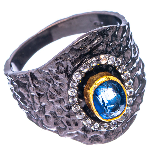 Black rhodium ring, textured band, blue oval center stone with diamond surround