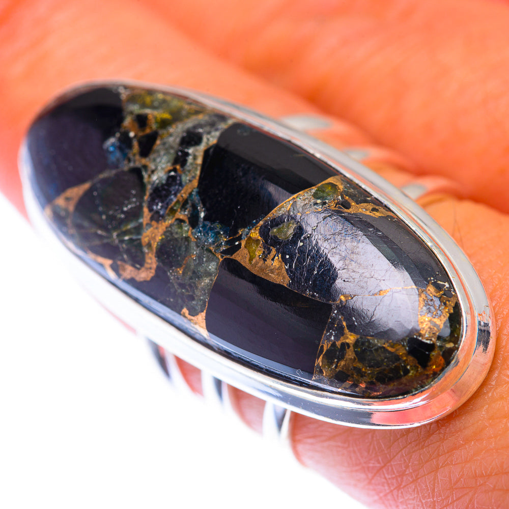 Sterling silver oval ring with dark onyx stone and gold speckled inlay, close-up
