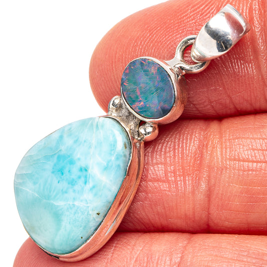 Sterling silver pendant with blue opal doublet and iridescent round stone