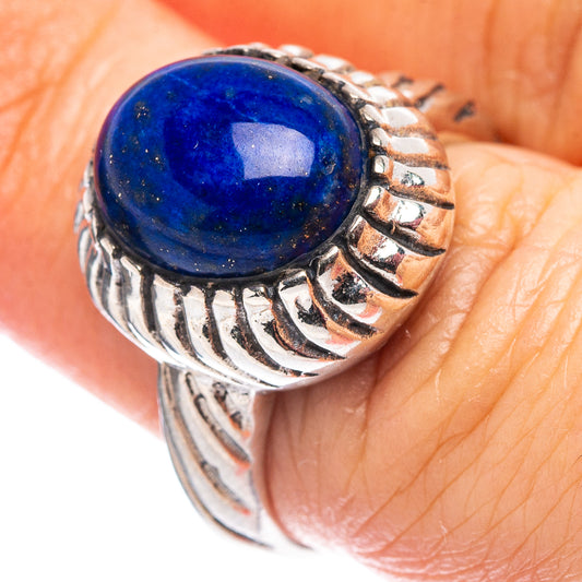 Sterling silver ring featuring a round blue lapis stone and carved patterned band