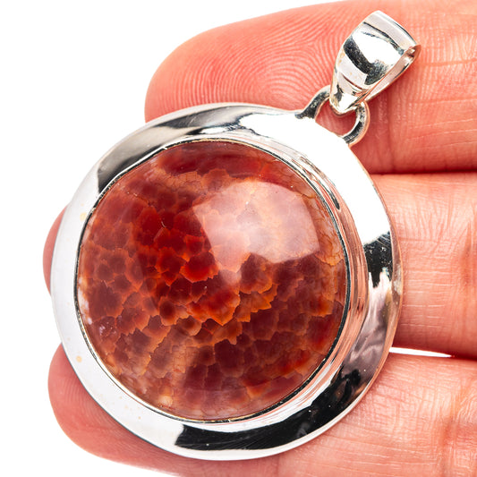 925 sterling silver pendant with round fire crab agate cabochon, red-orange translucent stone.