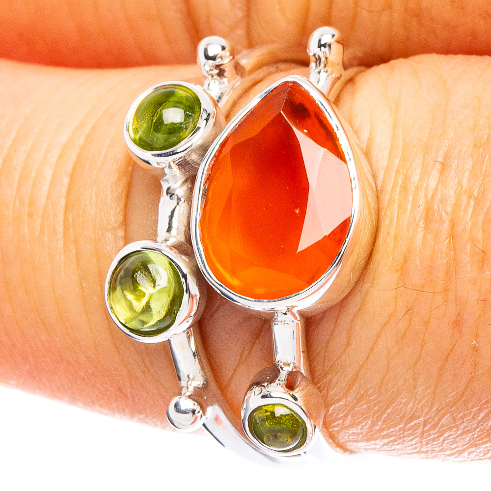 Oval orange carnelian ring in 925 sterling silver with three green peridot accents