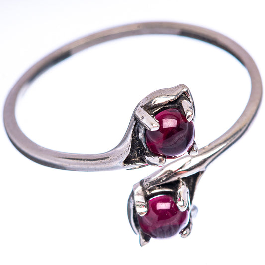 Sterling silver ring with two dark red garnet stones in raised settings