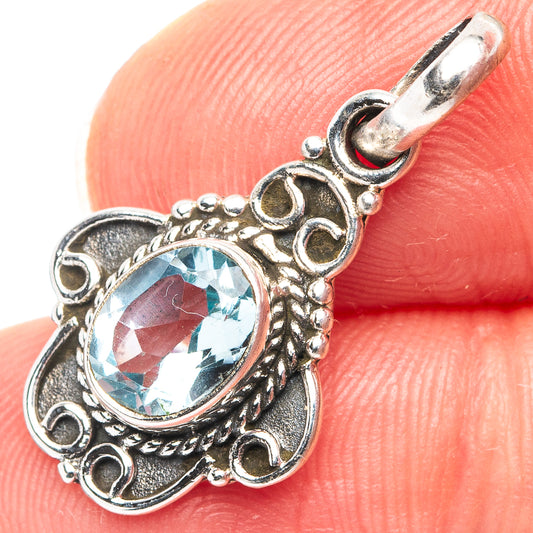 Sterling silver blue topaz pendant with ornate filigree and round gemstone