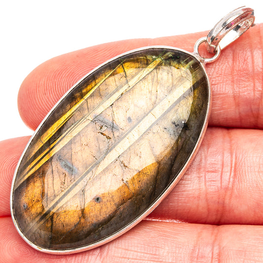 Oval labradorite pendant with silver-plated bail, streaked gold and gray labradorite.