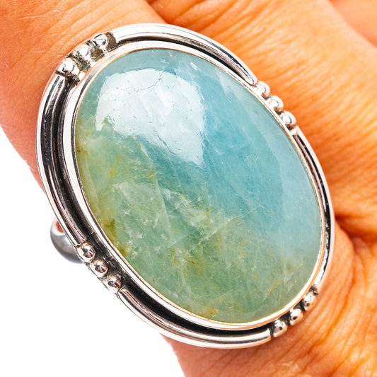 Oval aquamarine sterling silver ring with bezel-set oval stone and raised border