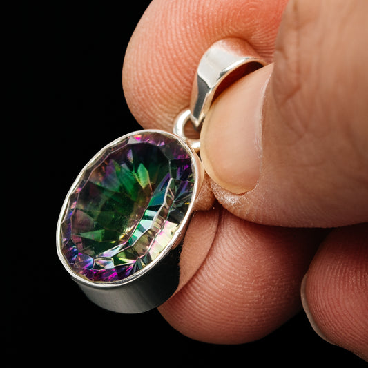Oval mystic topaz pendant detail with sterling silver side bail and bezel