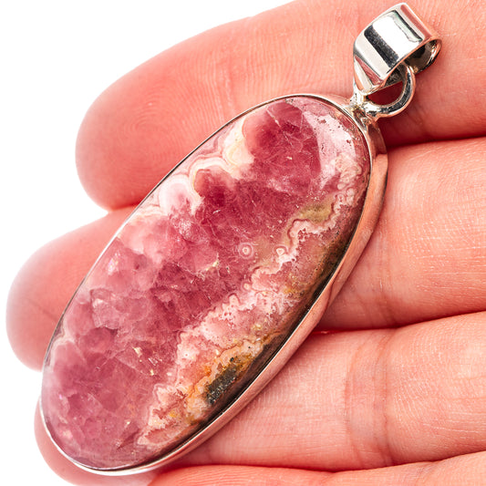 Rhodochrosite oval pendant close-up, pink stone with .925 sterling silver bezel
