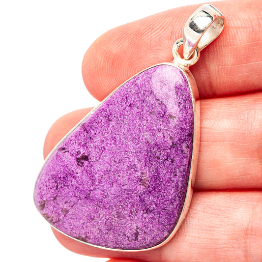 Purple purpurite teardrop pendant with .925 sterling silver bail, close to fingertip