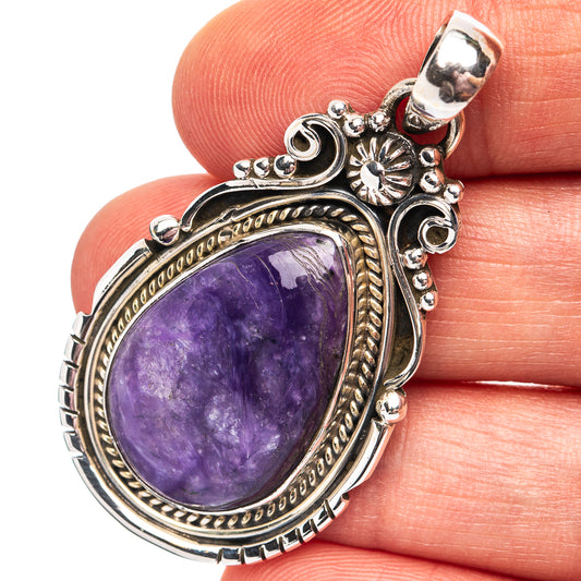 Oval purple charoite pendant in ornate sterling silver setting with bail