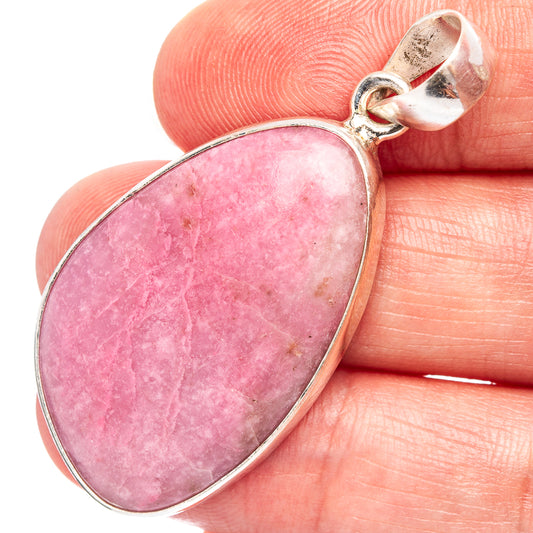 Pink thulite oval pendant close-up with sterling silver bail and bezel edge