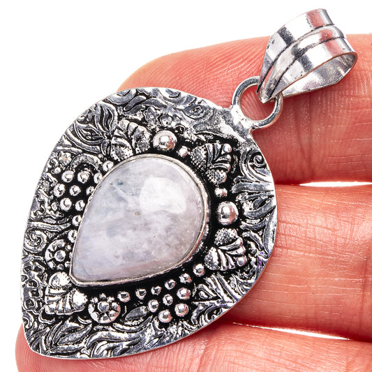German silver heart pendant with oval rainbow moonstone cabochon, ornate border