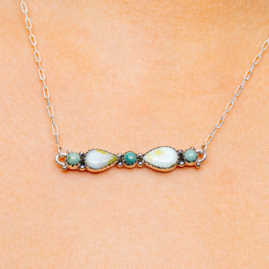 Turquoise and white stone necklace with silver chain and oval centerpiece