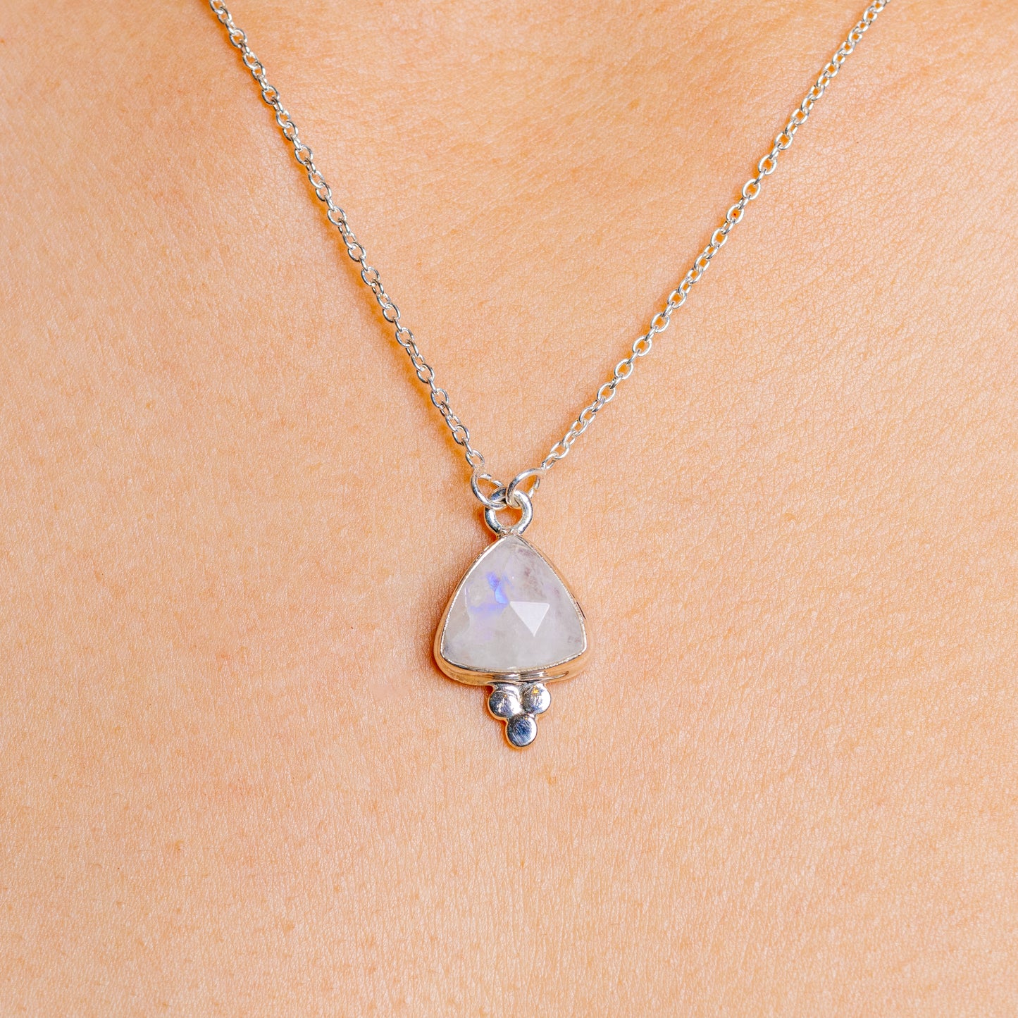 Sterling silver moonstone pendant necklace with pale blue faceted stone and small bead charm
