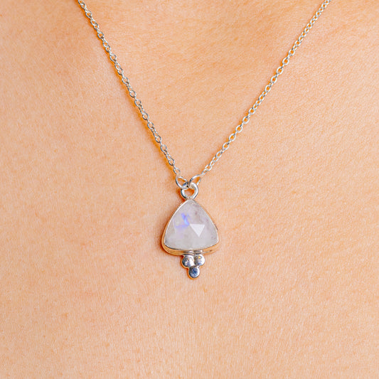 Sterling silver moonstone pendant necklace with pale blue faceted stone and small bead charm