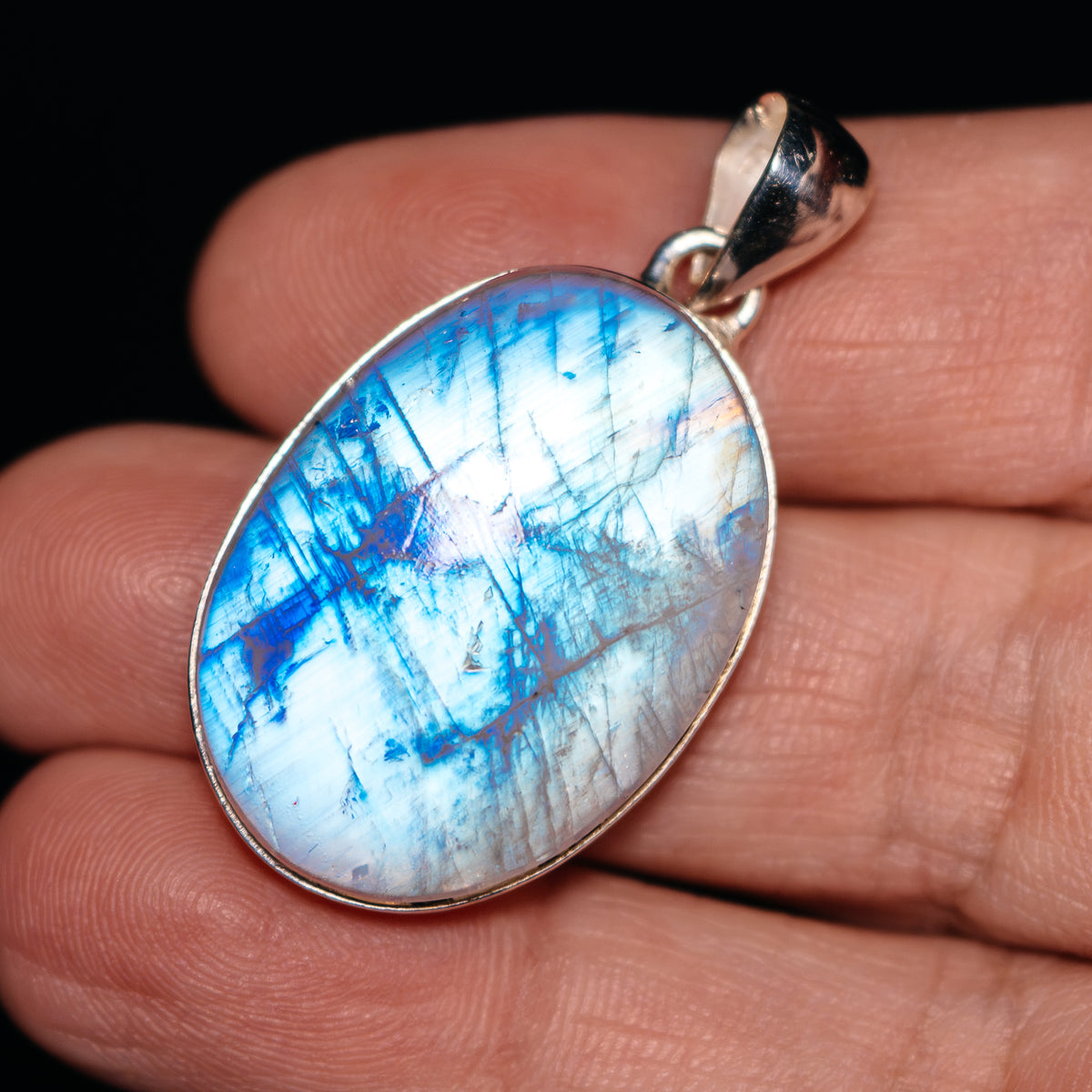 Sterling silver rainbow moonstone oval pendant with blue flash stone