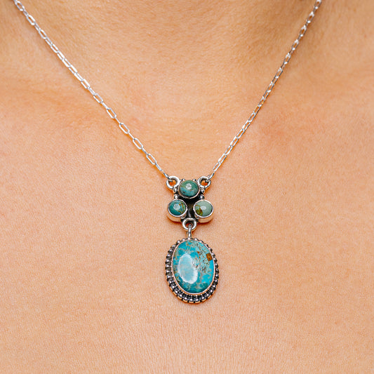 Turquoise oval pendant necklace with .925 silver chain and round green stone accents