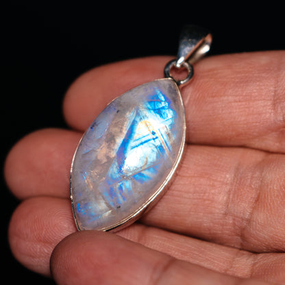 Oval rainbow moonstone pendant with .925 sterling silver bezel and bail